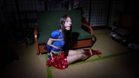 Supergirl is fitted with a gag